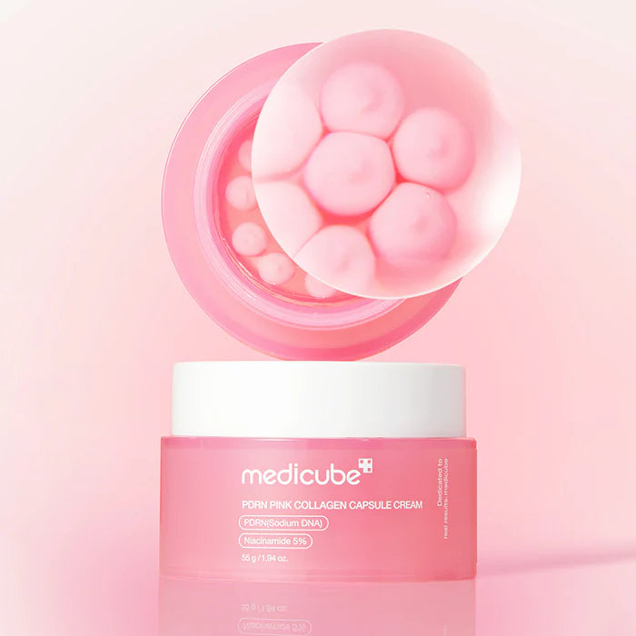 Rich pink active nutrient spheres melting smoothly into a transparent, ultra-plumping gel matrix texture of Medicube PDRN Collagen Capsule Cream at Atelier De Glow UAE.