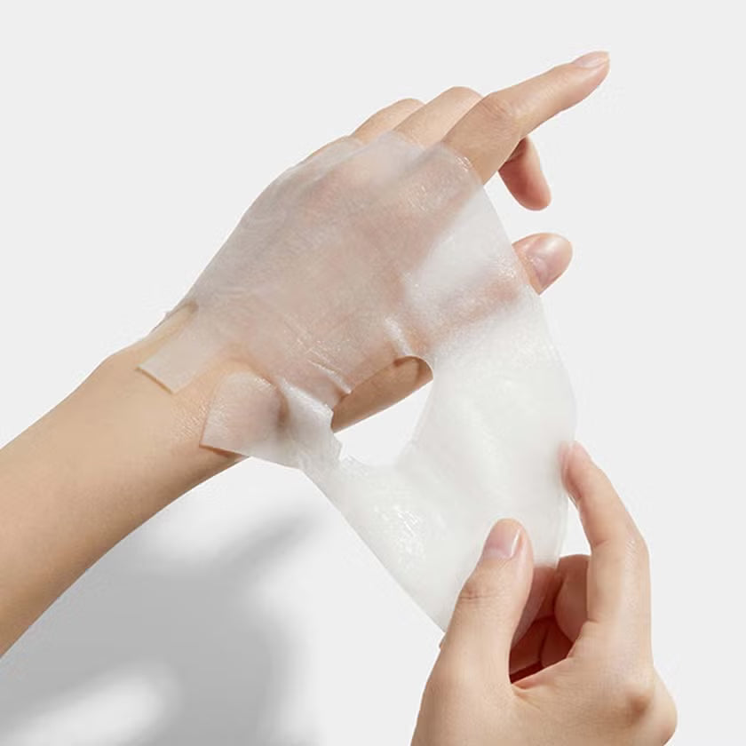 Plump, gelatinous, and ultra-adherent hydrogel-like sheet texture of Medicube Collagen Lifting Mask contouring perfectly to facial features at Atelier De Glow UAE.