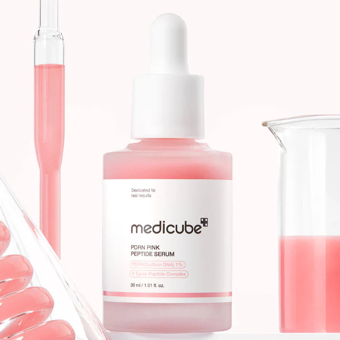 Silky, vibrant pastel pink fluid texture of Medicube Pink Peptide Serum absorbing weightlessly into the skin layers at Atelier De Glow UAE.