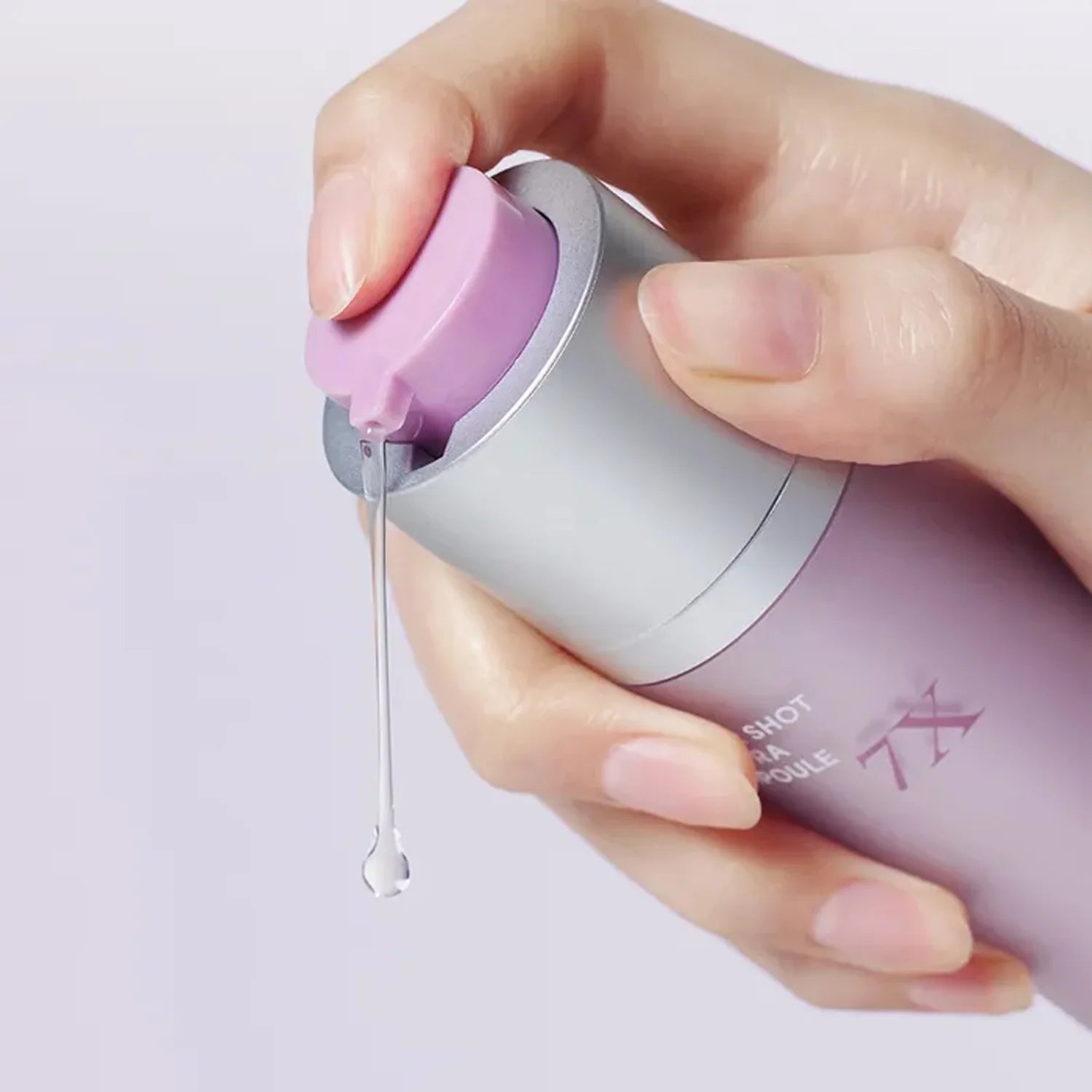 Rich, milky, and ultra-smooth fluid texture of Arocell Super Shot Coltra Ampoule 7X being dispensed from a dropper onto a clear face at Atelier De Glow UAE.