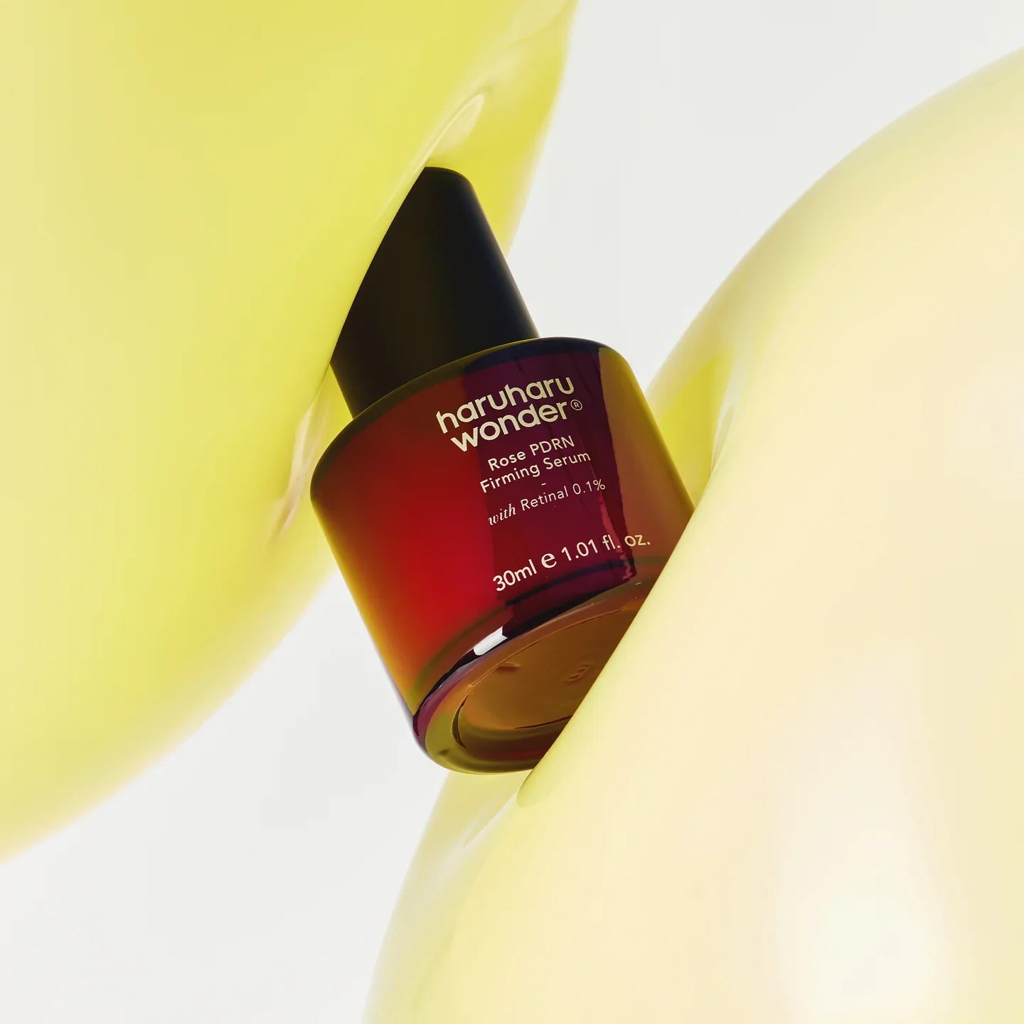 Silk-like, featherlight, and non-sticky clear fluid texture of Haruharu Wonder Rose PDRN Firming Serum absorbing instantly into a face at Atelier De Glow UAE.