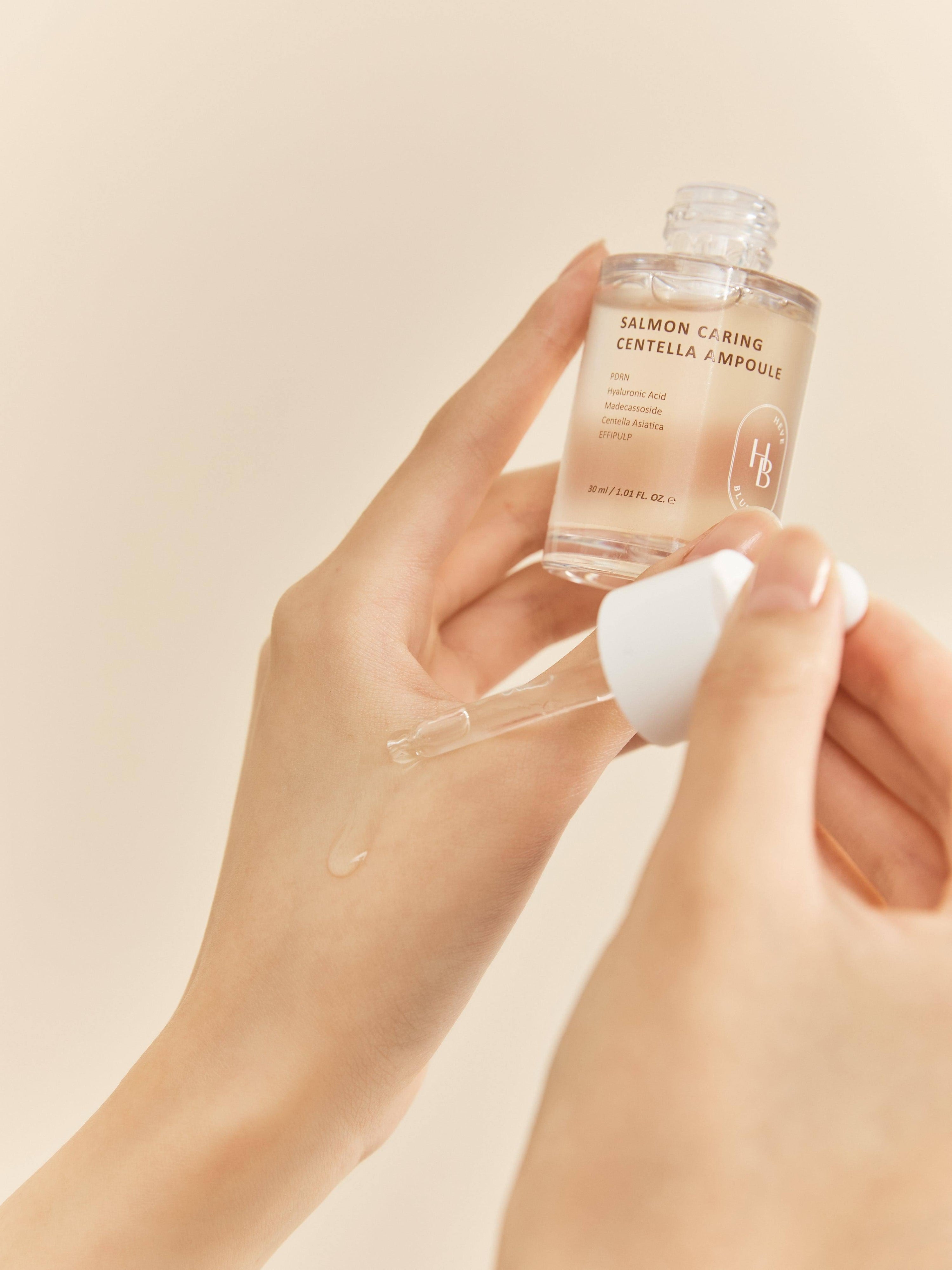 Silky, concentrated ampoule texture of HEVEBLUE Salmon Centella – Fast-absorbing, soothing liquid for irritated and post-procedure skin at Atelier De Glow UAE.