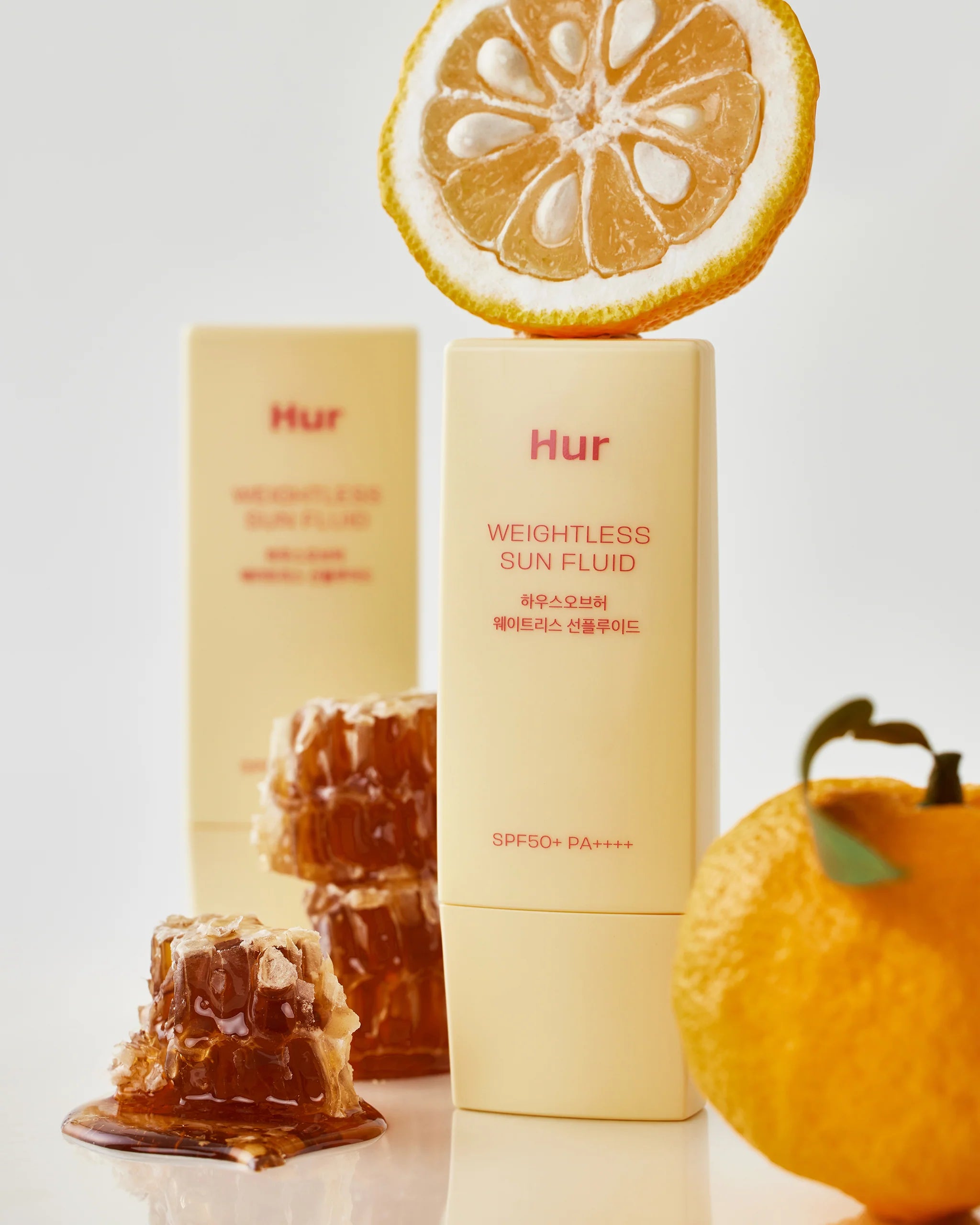 Water-like, fluid texture of House of Hur Sun Fluid β Fast-absorbing, invisible daily SPF for active lifestyles at Atelier De Glow UAE.