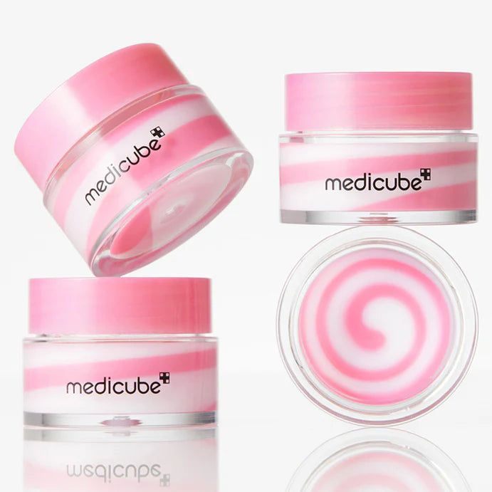 Cushion-soft, smooth-melting, and sheer naturally pink glossy balm texture of Medicube PDRN Lip Mask gliding over parched skin canvas at Atelier De Glow UAE.