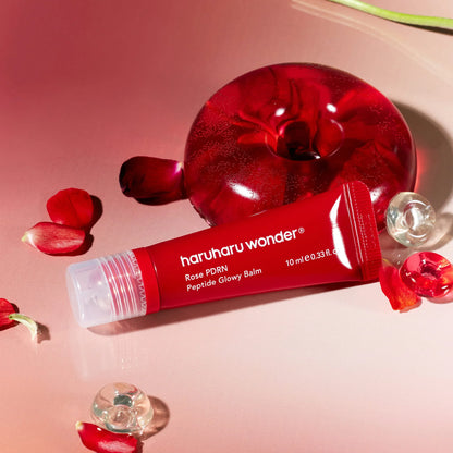 Smooth, solid, and buttery-soft clear pink glaze texture of Haruharu Wonder Rose PDRN Balm gliding effortlessly over skin contours at Atelier De Glow UAE.