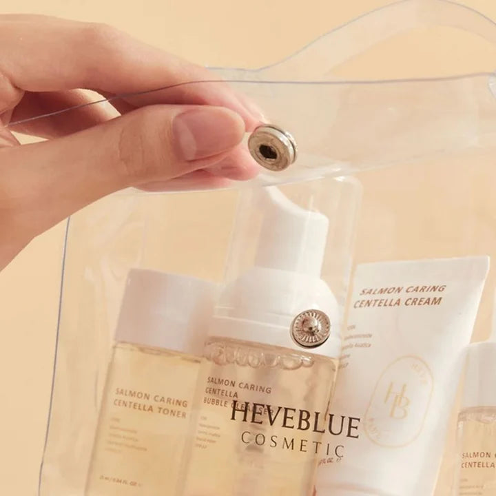 Premium waterproof travel bag with HEVEBLUE Salmon Centella miniatures – TSA-friendly clinical skincare for luxury travel at Atelier De Glow UAE.