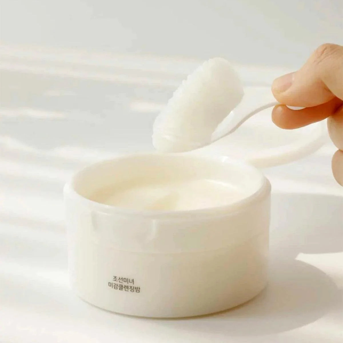 Sherbet-to-oil texture of Beauty of Joseon Radiance Cleansing Balm – Luxurious Korean skincare for "Glass Skin" double cleansing at Atelier De Glow UAE.