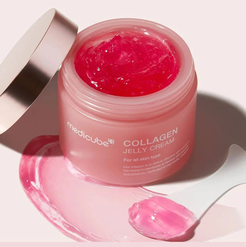 Bouncy, pink-tinted transparent gel-jelly texture of Medicube Collagen Niacinamide Cream melting smoothly into a dewy finish at Atelier De Glow UAE.