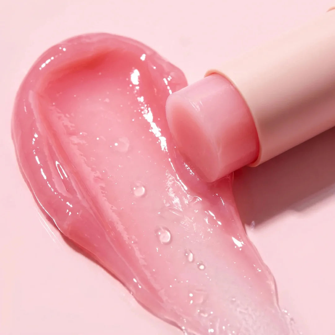 Solid, pastel pink, and ultra-smooth balm texture of Medicube PDRN Pink Collagen Volume Multi Balm gliding effortlessly onto a clear face at Atelier De Glow UAE.