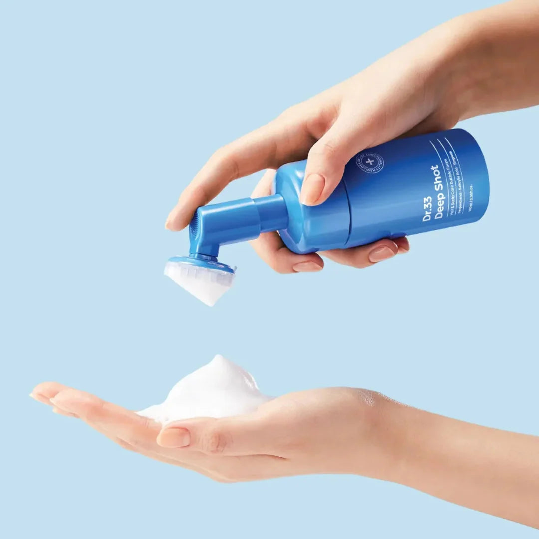 Effervescent, white, and crackling micro-bubble foam texture of seapuri Scalpy Bubble Tonic being massaged directly onto hair parts at Atelier De Glow UAE.