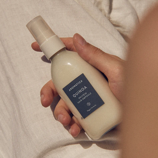 Lightweight, non-greasy mist of AROMATICA Quinoa Protein Ampoule – Concentrated Korean hair serum for "Glass Hair" smoothness at Atelier De Glow UAE.
