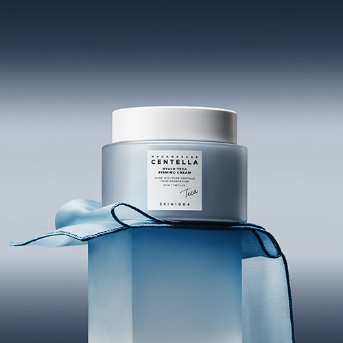 Rich, whipped, and cushion-soft light blue cream texture of SKIN1004 Madagascar Centella Hyalu-Cica Firming Cream melting effortlessly into a face at Atelier De Glow UAE.