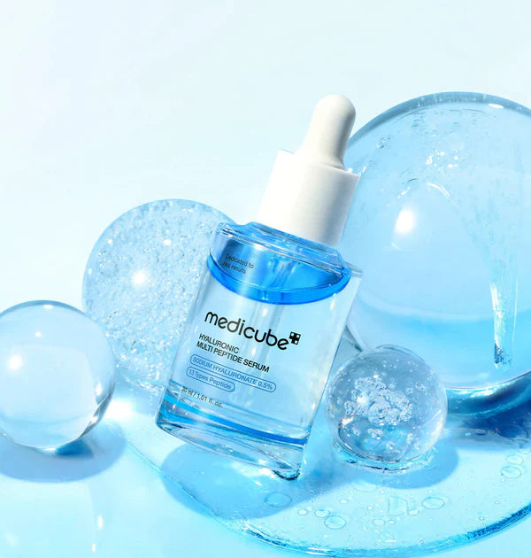 Slinky, ultra-plumping, and crystal-clear fluid texture of Medicube Hyaluronic Multi Peptide Serum melting instantly into a skin barrier at Atelier De Glow UAE.
