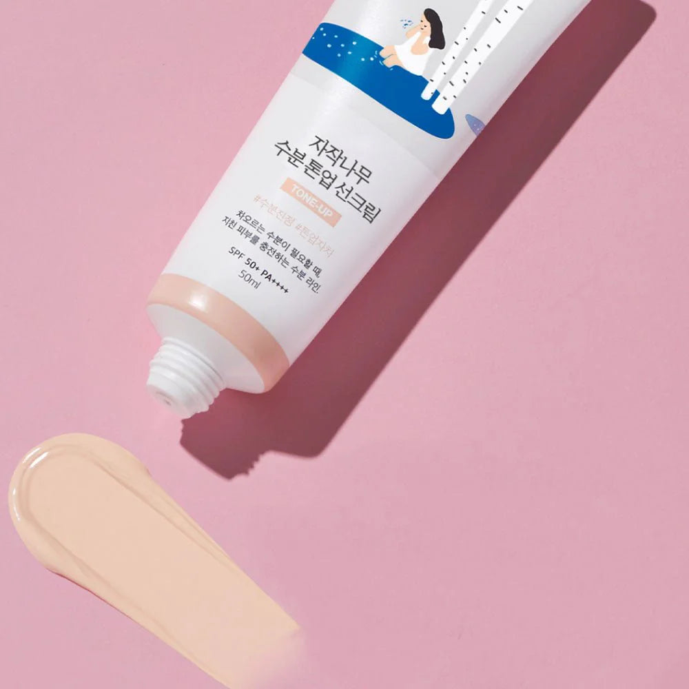 Lightweight, cream-to-lotion texture of Round Lab Birch Juice Tone Up Sunscreen that leaves skin feeling deeply moisturized and radiant at Atelier De Glow UAE.