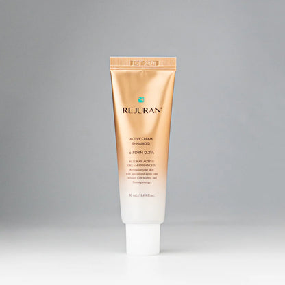 Rich, whipped, and cushion-soft white cream texture of REJURAN Active Cream Enhanced melting effortlessly into a face at Atelier De Glow UAE.